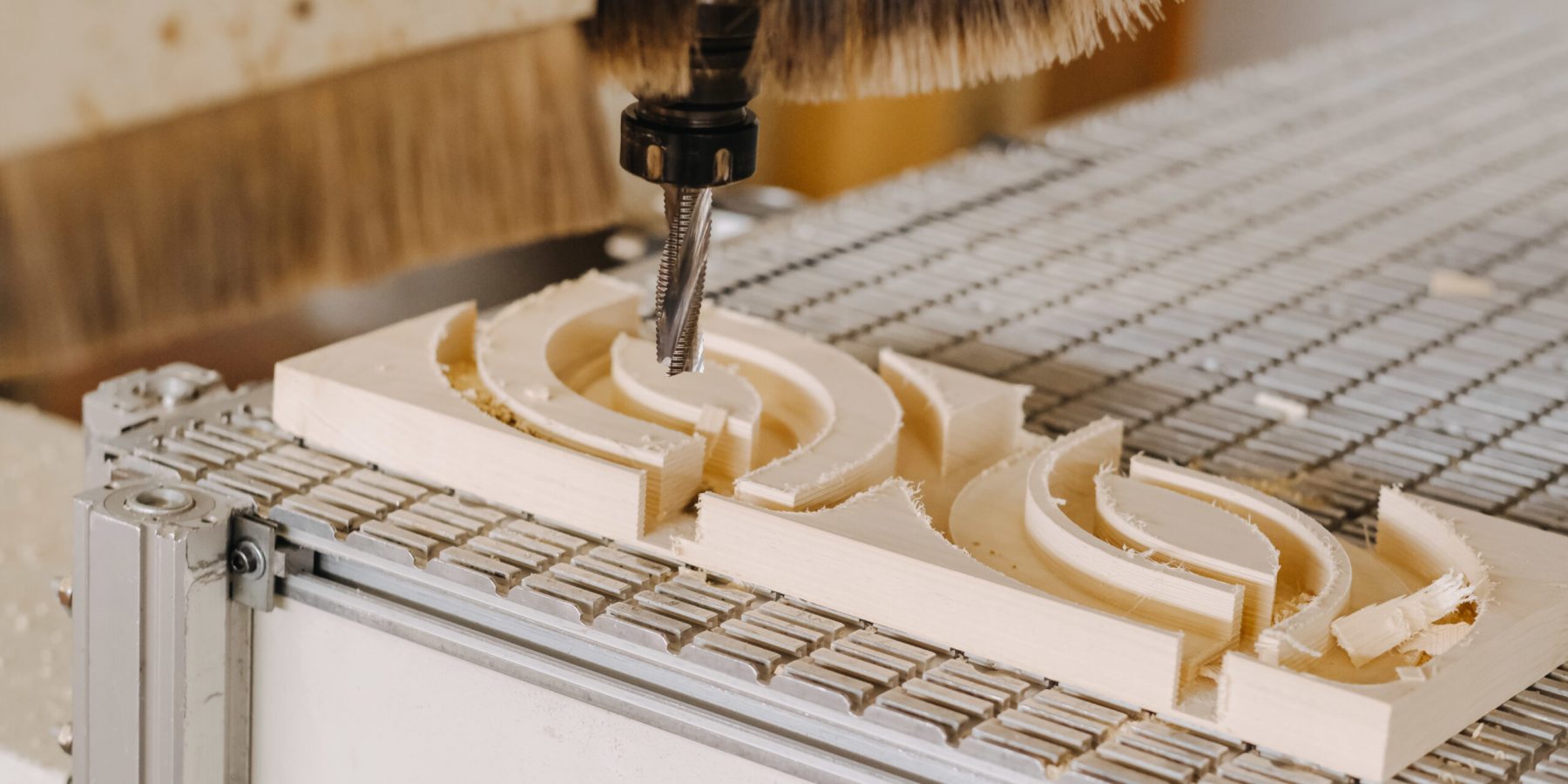 A closeup shot of an industrial plywood carving machine at work